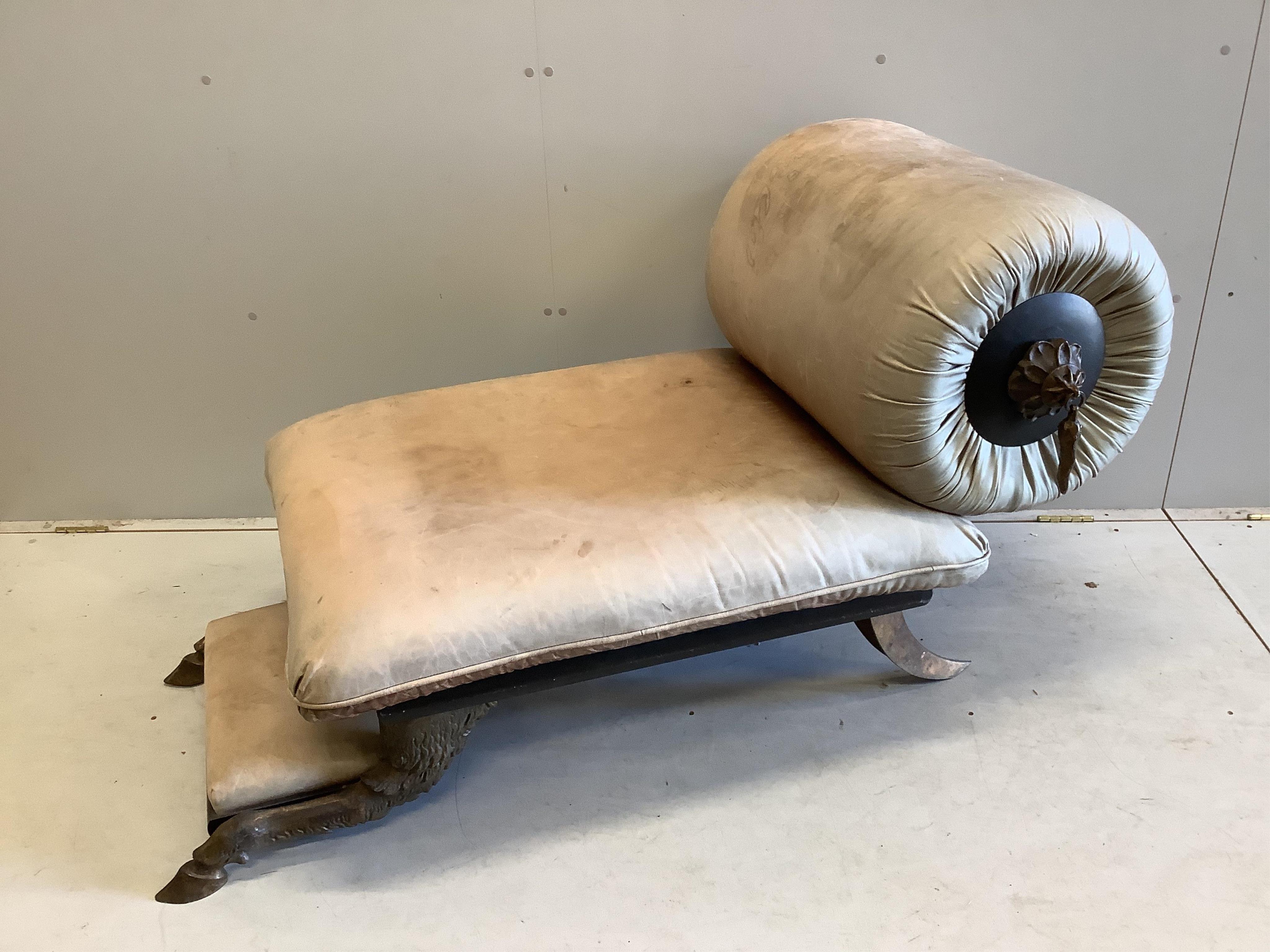 A Contemporary leather upholstered small chaise with animal hoof feet, width 128cm, depth 72cm, height 80cm. Condition - fair